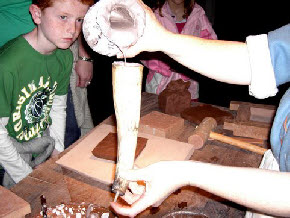 White clay slip poured into a cow's horn slip trailer