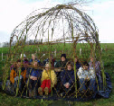 Teachers in the willow dome that they built