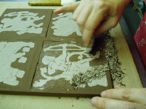 Carving white clay slip to reveal the encaustic pattern
