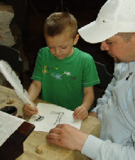 Illuminated letter writing with a quill pen and ink