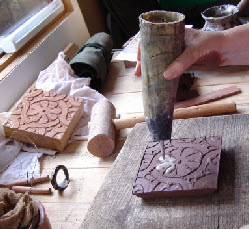 Cow's horn slip trailer fills the pattern with white earthenware clay